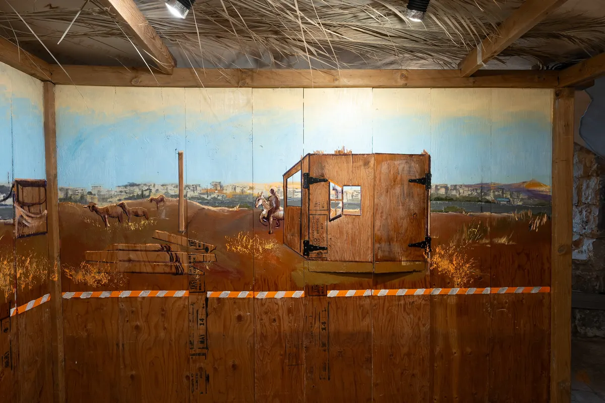 Painting of a man on horse behind a sukkah hut