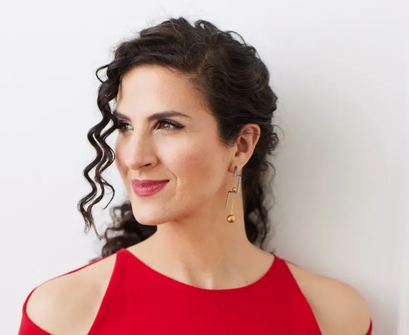 Laila Biali wears a red dress.