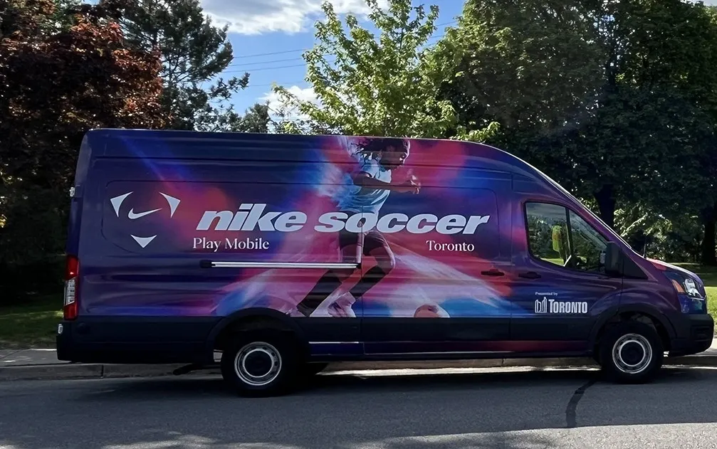 A van brightly painted that reads Nike Soccer Play Mobile